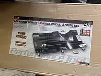 Box of the low profile mechanic's creeper showing the product image, branding, and key features such as six casters, padded headrest, and storage tray.
