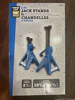 Two blue Power Fist jack stands displayed side by side, showing height adjustment capabilities and product labeling.