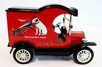 Red 1912 Ford Model T toy delivery van with RCA Victor 'His Master's Voice' logo on the side, showing coin bank shape and design details.