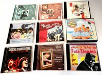 Photo showing first 9 CDs including Folk Legends, Bluegrass Legends, multiple Beach Boys albums, Monkees, Creedence Clearwater Revival, Fats Domino, and Chuck Berry.