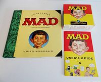 Photo of the set including the 'Completely MAD' hardcover book, box of 7 MAD Magazine CD-ROMs, and MAD User's Guide booklet.