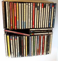 Top-down view of two stacks of CDs showing spines with titles and artists