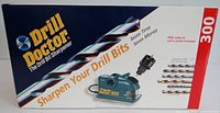 Box front view showing drill bit sharpener and text 'Sharpen Your Drill Bits' and 'Saves Time Saves Money'. Includes image of drill bit sharpener with chuck and bits.