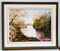 Frontal view of the framed original oil painting depicting autumn trees and a river.