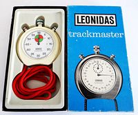 Photo showing the Leonidas Trackmaster stopwatch in its original box alongside the blue branded box with illustrated stopwatch on cover.
