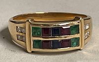 Front view showing two rows of square-cut colored gemstones in yellow gold setting