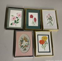 Lot of five framed and unframed floral watercolor paintings by Kathleen Clegg, arranged on flat surface.