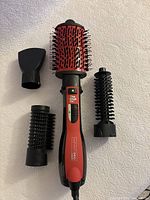 Full set laid flat on white background showing main brush, three attachments and handle.