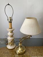 Both lamps displayed side by side showing ceramic floral base lamp and brass adjustable arm lamp with shade