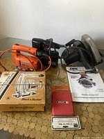 Top view of four power saws including three jigsaws and one Skil circular saw confirming presence of manuals and Black & Decker box.
