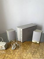 Overall shot of the Labtec Spatializer speaker system showing two satellite speakers, subwoofer, power adapter and cables.