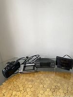 Four alarm clocks on a table against a white wall including Sony digital clock radio and a black Zenith clock.