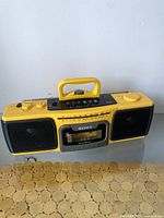 Front and slight angle view of yellow Sony CFS-920 portable stereo with cassette player and speakers showing controls and brand name.