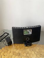 Full view of Teac iPod dock with power adapter, showing the unit and cords on a surface.