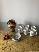 Photo shows all items in the vintage decor lot: pottery vase, six Crown Royal mugs, ceramic ashtray, and four shot glasses.