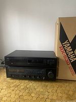 Photo showing Yamaha RX-530 AV receiver with original box, units stacked on a surface.