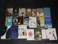 Lot of 20 modern books arranged on floor with titles and authors visible, showing condition and variety in subject matter.