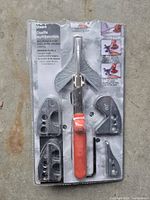 Front view of Sheffield shear set in plastic packaging showing handle with orange grip and 4 interchangeable shear heads