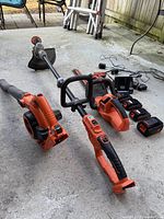 Overview of drill, hedge trimmer, edge trimmer, blower, batteries and chargers