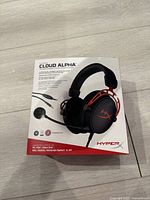 Boxed HyperX Cloud Alpha headset showing product image and compatibility info.