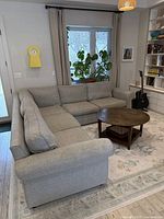 Overall view of L-shaped sectional sofa in living room, showing configuration and style