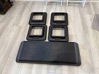 Step aerobics platform with four risers separated on floor, showing item count and condition.