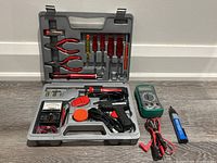 Full set in gray plastic carrying case with hand tools and meters.