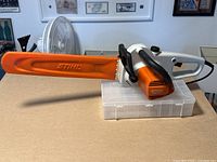 Side view of chainsaw with protective cover installed