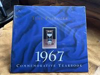 Front cover of the sealed 1967 commemorative yearbook calendar titled 'Time Passages' with blue background and hourglass image.