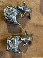 Top view of the pair of solid brass ram figurines showing the detailed curved horns and textured bodies.