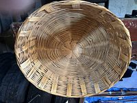 Top-down view inside the round wicker basket showing woven circular pattern and condition.