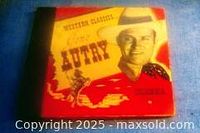 Cover for Western Classics album featuring Gene Autry in cowboy hat and outfit, with red and yellow western-themed graphics.