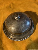 Closed view of the vintage Birks sterling silver butter dish with detailed lid and beaded rim base.