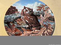 Front of round brown owl wall plate with detailed painted owl and fall foliage scene.