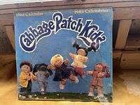 Front of the 1985 Cabbage Patch Kids calendar showing colorful doll illustrations and title.
