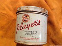 Front view of the vintage Player's cigarette tobacco can showing branding and text.