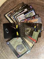 Photo showing a spread of 35 BIONICLE trading cards with various characters and items depicted in good condition.