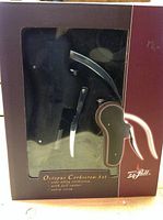 Photo of the boxed Octopus Corkscrew set showing the corkscrew, foil cutter, and extra screw inside the packaging