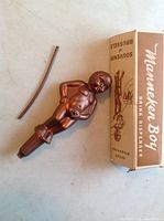 Vintage plastic Manneken Pis shaped drink dispenser with original box and dispensing tube visible, 5 inches tall, copper color.