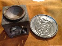 Soapstone square oil burner with pentagram cut-out from top angle showing the hollow interior and opening for a tealight candle.