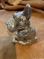 Front side view of the silver plate Scottie dog money bank showing detailed fur texture and upright ears.