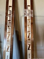 Close-up of Lafsanen branding on skis showing brown and white color scheme with logo and 'Made' text.