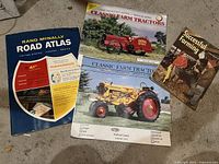 Four vintage publications on floor: Rand McNally Road Atlas, two Classic Farm Tractors magazines, Successful Farming book