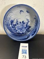 Top view showing detailed cobalt blue floral and butterfly motifs inside the bowl.