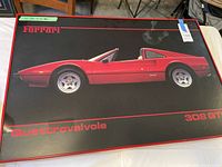 Full view of the framed poster showing the Ferrari 308 GTS car in red, labeled 'Ferrari', 'Quattrovalvole', and '308 GTS'.