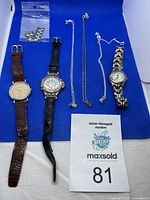 Overview of three watches, three necklaces, extra bracelet links bag