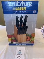 Front view of Wiltshire Laser 13 piece cutlery block set box showing knives in wood stand and brand logo.