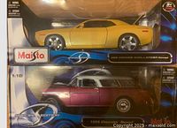 Frontal view of Maisto 1:18 die cast cars in original packaging showing the yellow 2008 Dodge Challenger Concept and maroon 1955 Chevrolet Nomad models stacked vertically within clear plastic display box.