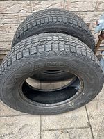 Photo of two black Winterforce winter tires with size markings P245/70/R17, showing tread and sidewall details.