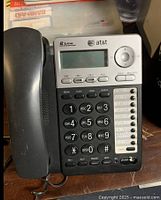 First AT&T 2 line speakerphone showing numeric keypad, line selection buttons and handset on left side.